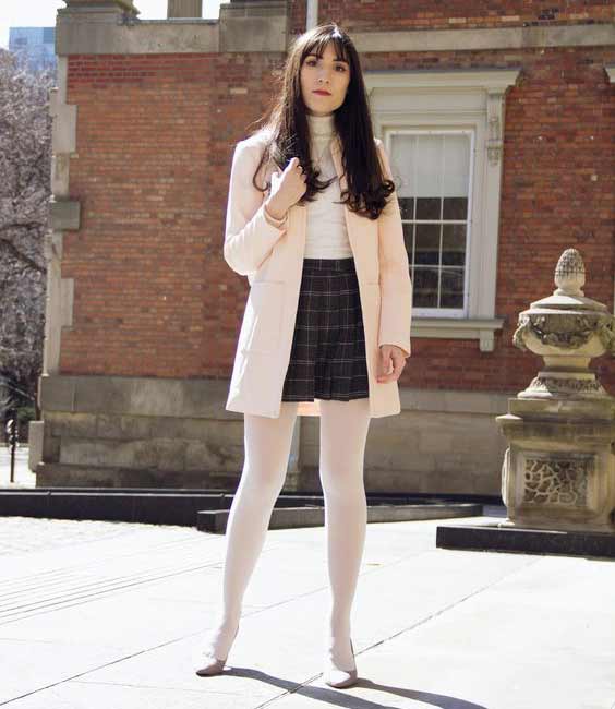 White tights match with a pink trench coat