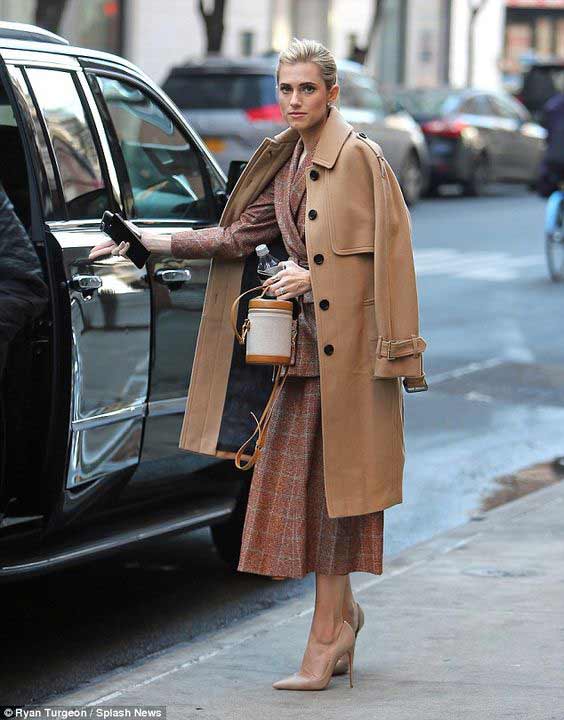 Allison Williams in a beige trench coat