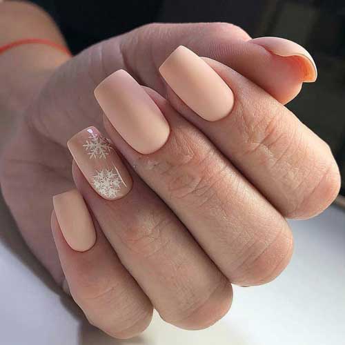 Beige manicure with snowflakes