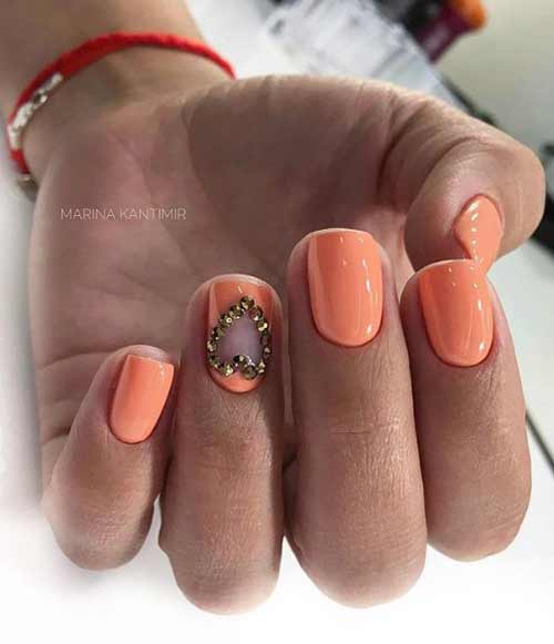 Coral manicure with rhinestones heart