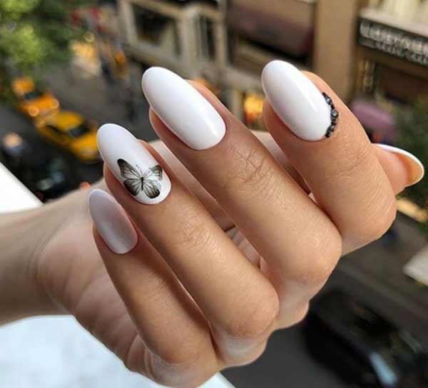 White manicure with a butterfly on March 8