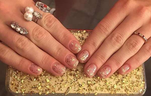 Bare nails for the new year with gold sequins