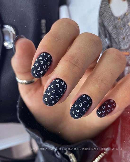 Black manicure with hearts