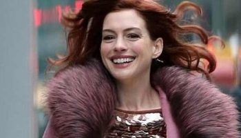 Anne Hathaway insulated with taste: a winter coat, sequins and a bright skirt