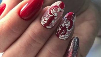 Red manicure with monograms