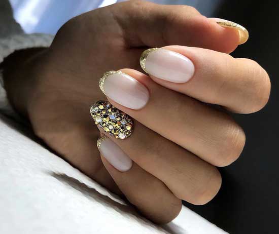 Milk manicure with gold sparkles and rhinestones