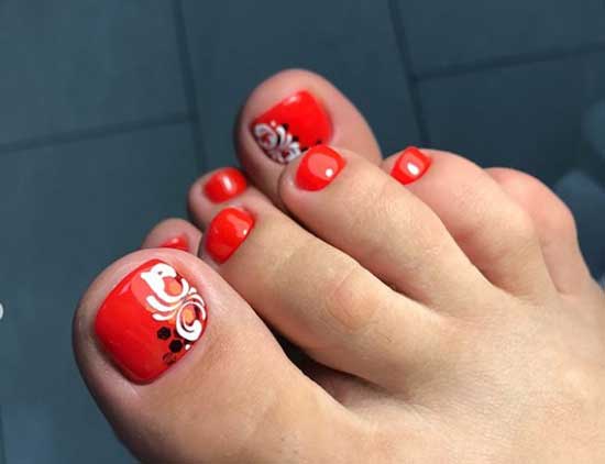 Flowers and monograms on a red background of toenails