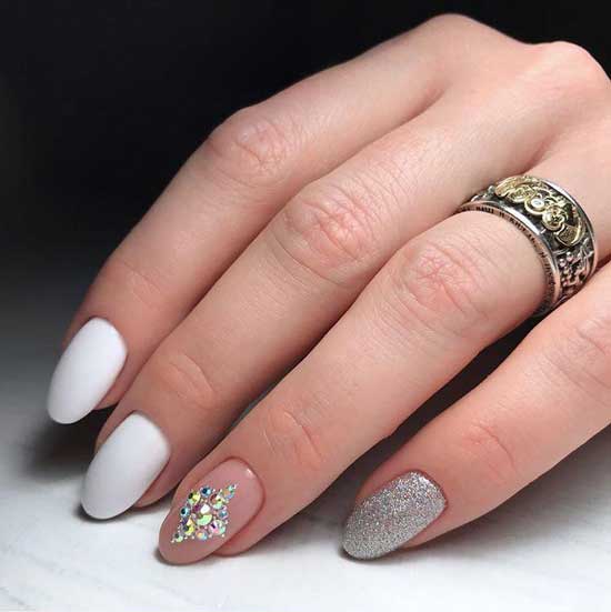 White manicure with sparkles and rhinestones - bright design