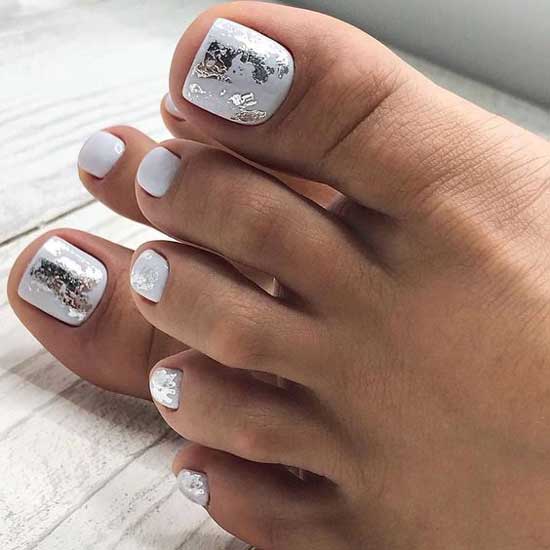 Beautiful white pedicure with foil