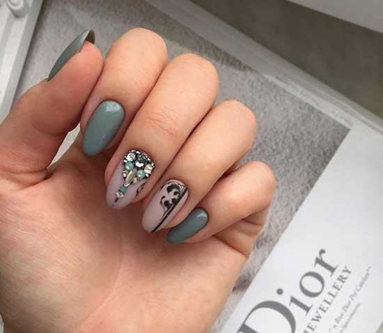 Stripes and rhinestones in manicure