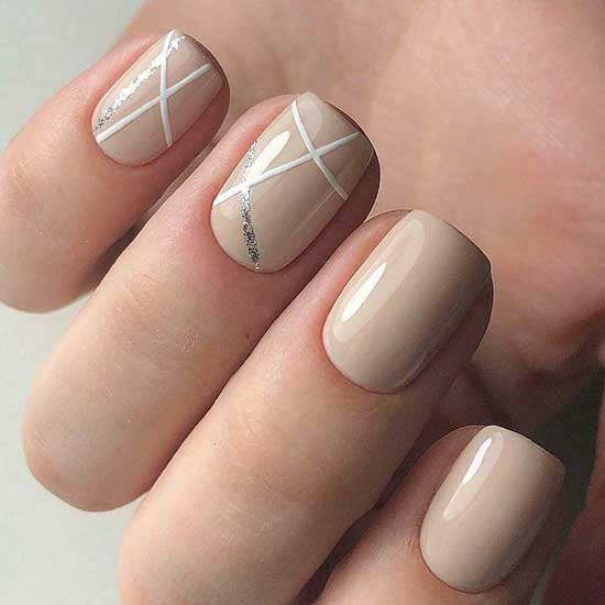 Beige manicure with watercolor and shiny stripes