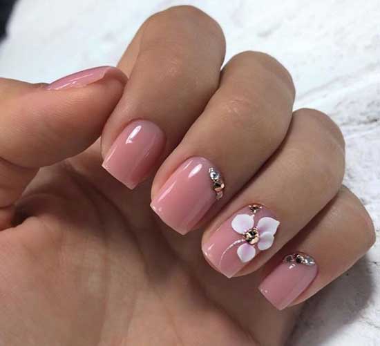 Manicure in beige tones with a volumetric decoration in the form of a flower