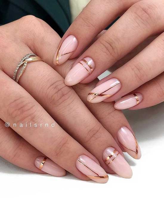 Light pink manicure with gold stripes