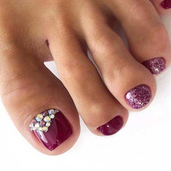 Pedicure in rich colors with sparkles and rhinestones