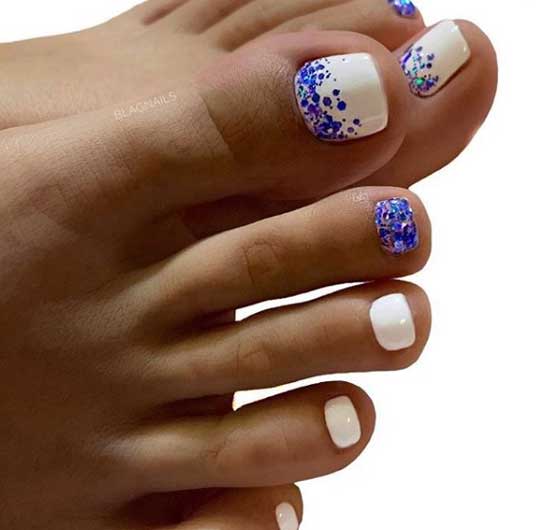 White pedicure with blue sequins