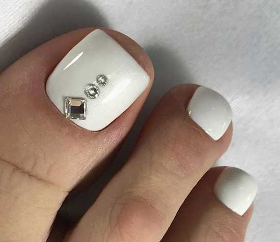 Photo of a white fashionable pedicure with the design of 2019-2020 - top new ideas