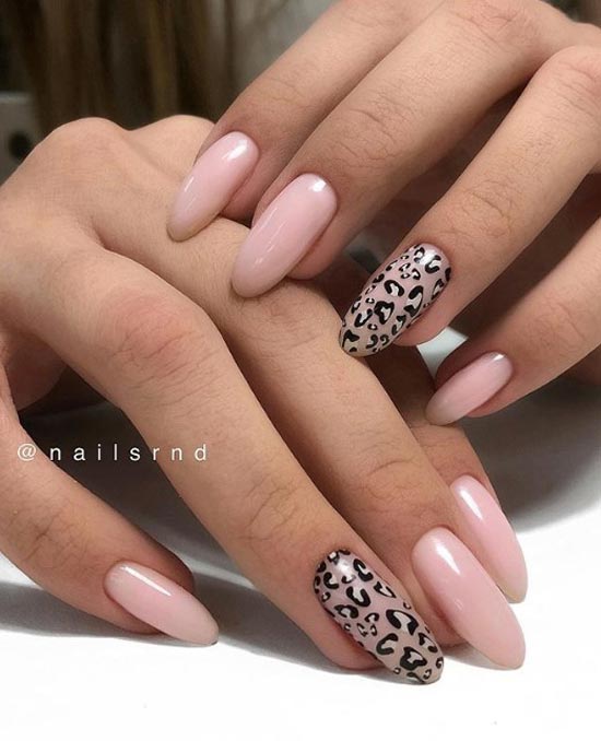 Nude manicure with an accent on one nail in a leopard print