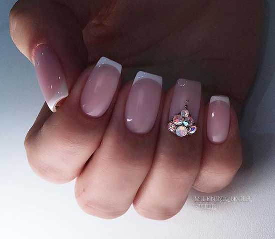 Beautiful manicure French design with large rhinestones