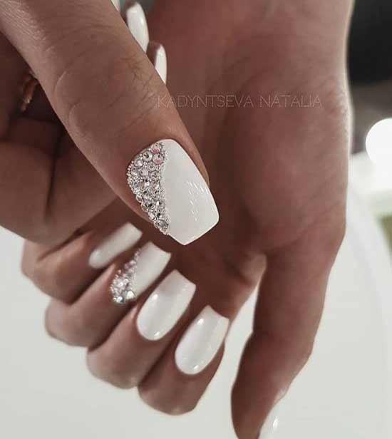 White manicure with transparent rhinestones