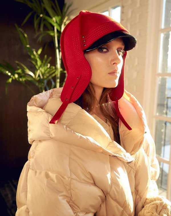 Red hat with earflaps and beige down jacket