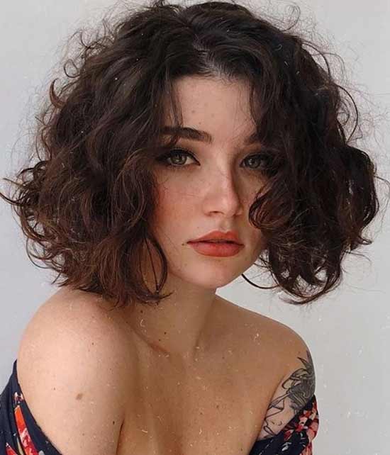 Curly hair cut to the shoulders with natural styling