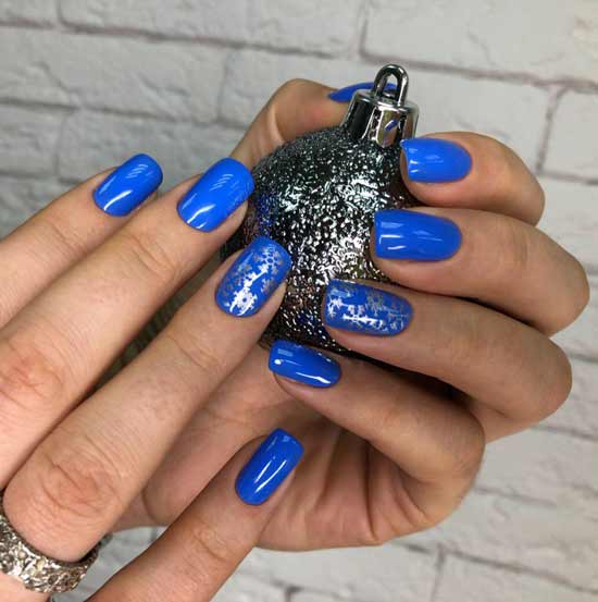 Blue christmas manicure design with snowflakes