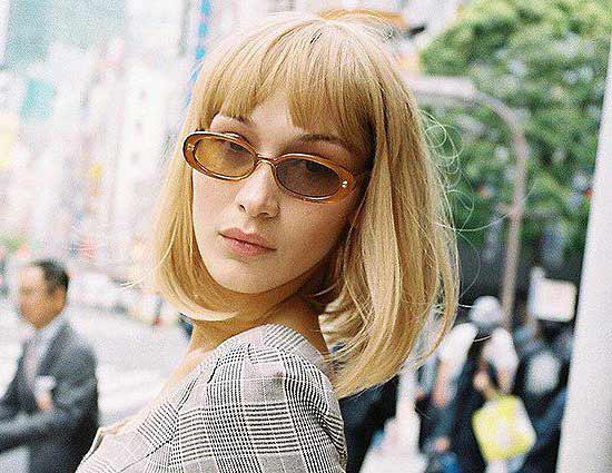 Bella Hadid's haircut with medium length and bangs