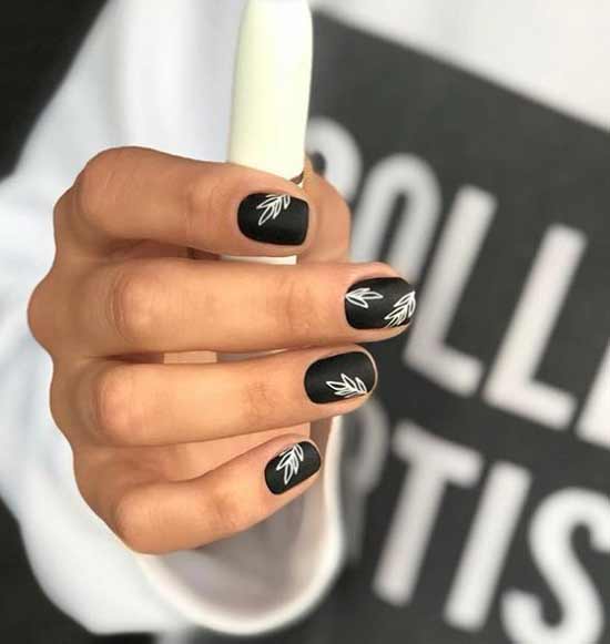 Black manicure with white pattern