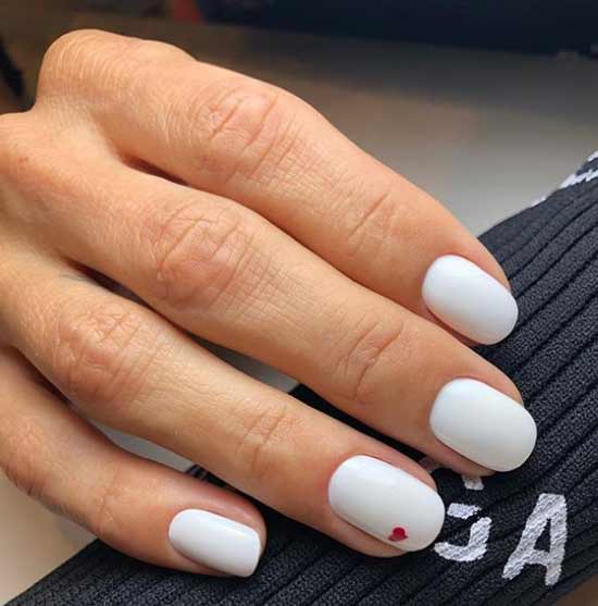 White manicure with a heart spring