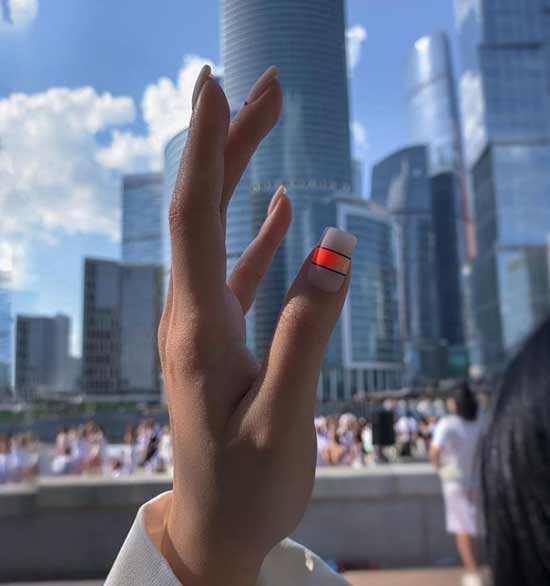 Bright orange accent in spring manicure