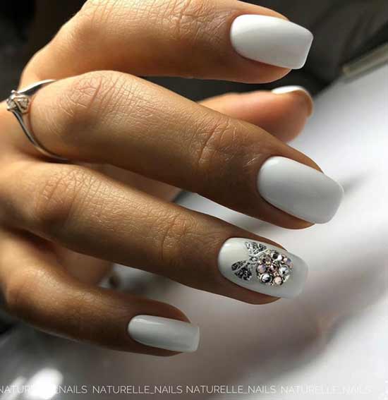 White manicure with rhinestones