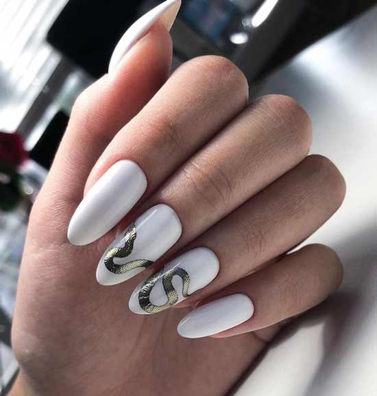 White manicure and golden snake