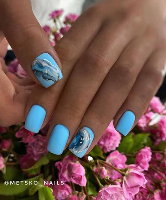 Blue nail design on tanned hands