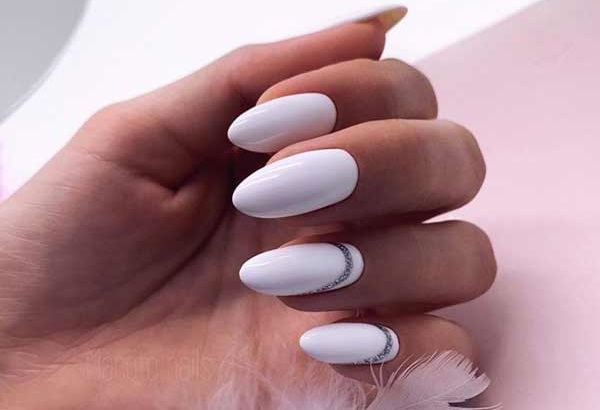 Beautiful white manicure with decor