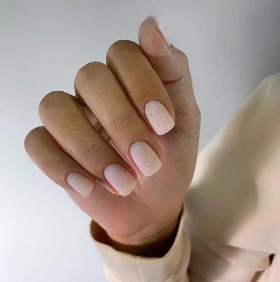 Matte beige manicure with fine sparkles