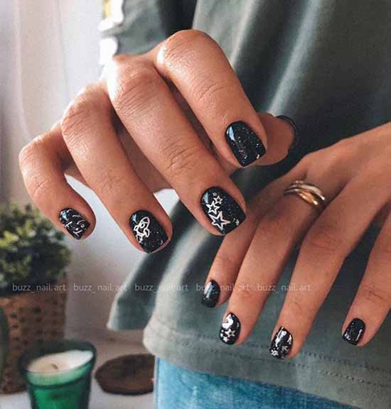 Black manicure with glitter and stickers