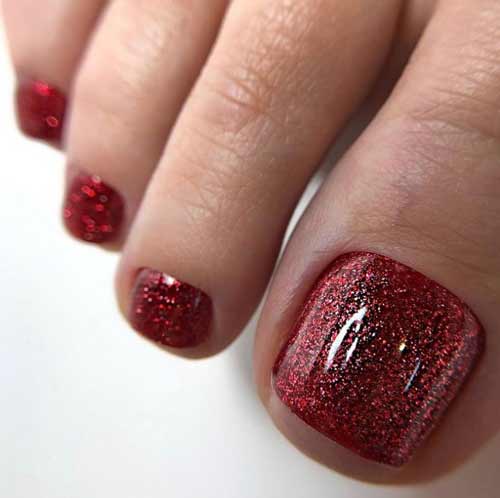 Red pedicure with glitter