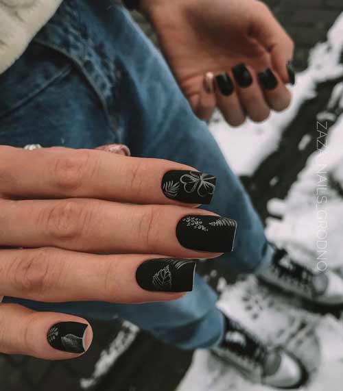 Black manicure in the photo