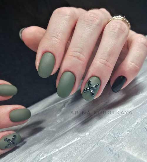 Matte green manicure and black rhinestones