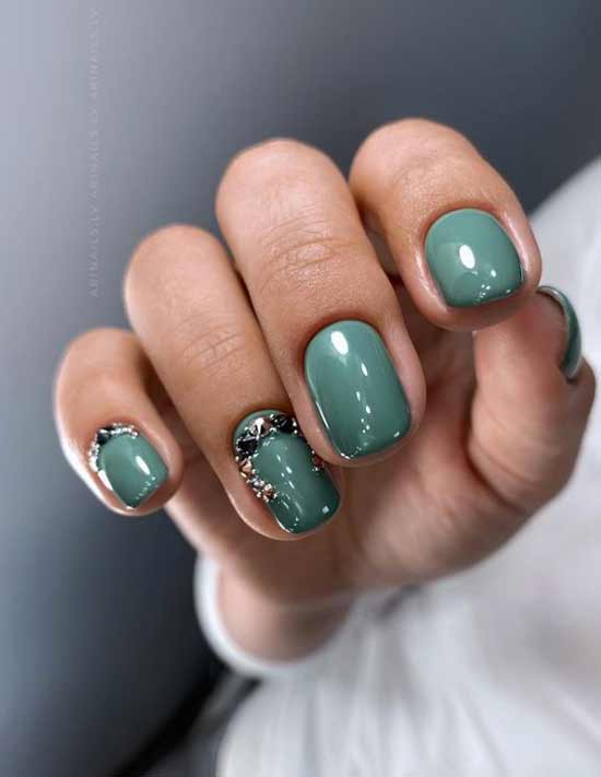 Green nail design with rhinestones