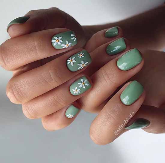 Green manicure with daisies