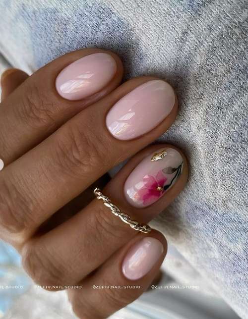 Pink manicure with a flower to match