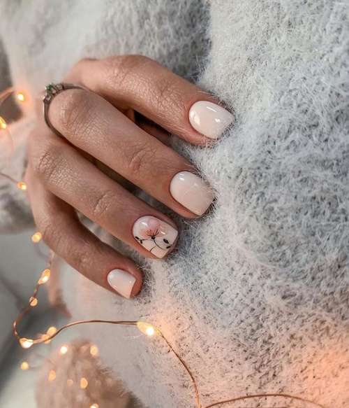 Beige manicure with a flower