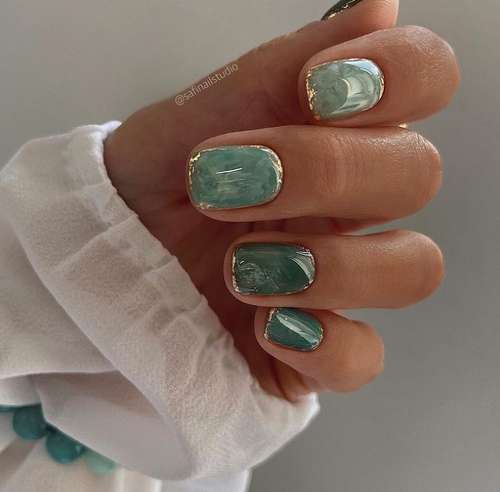 Green manicure with gold