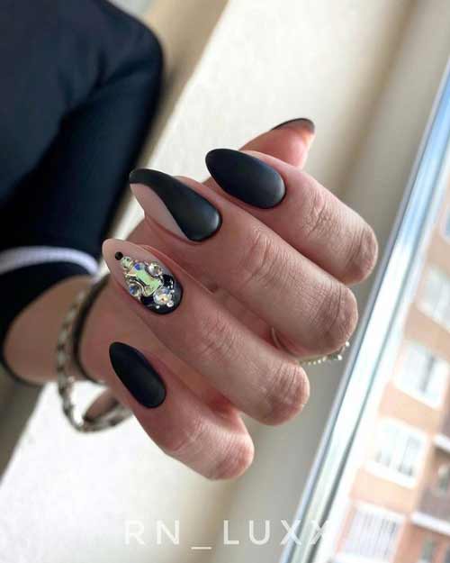 Black manicure with gold rhinestones