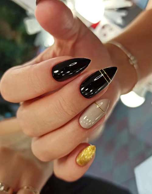 Long black and gold nails