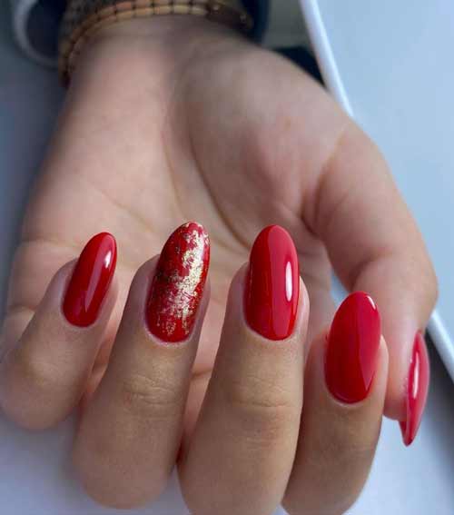 Red manicure with gold foil