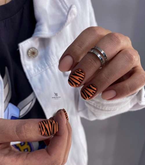 Orange manicure with zebra