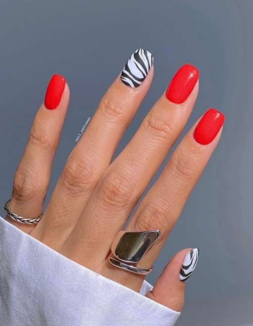 Red manicure with zebra print