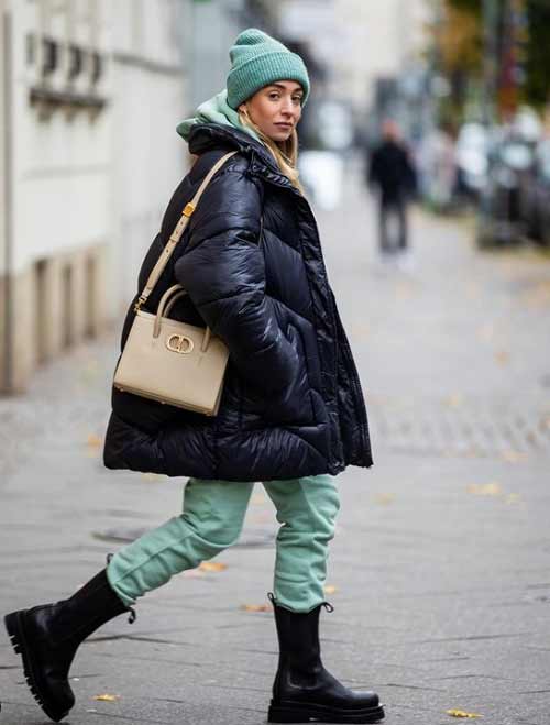 Black down jacket and green accessories